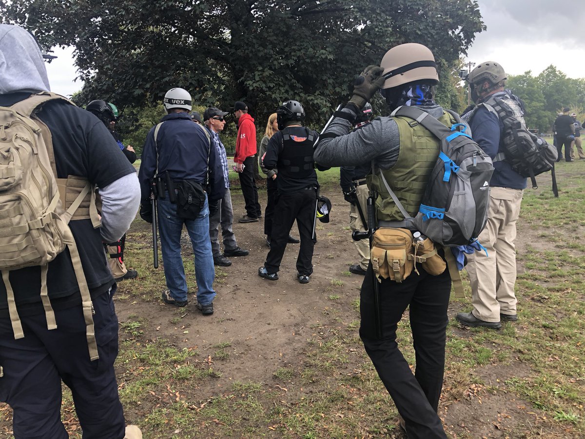 A handful of attendees are wearing handguns, but mace and clubs are a lot more abundant.