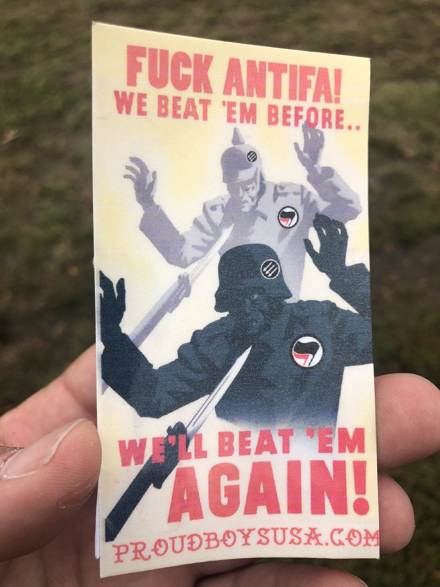 They’re handing out fliers / stickers in the style of WWII and Red Scare-eta art.