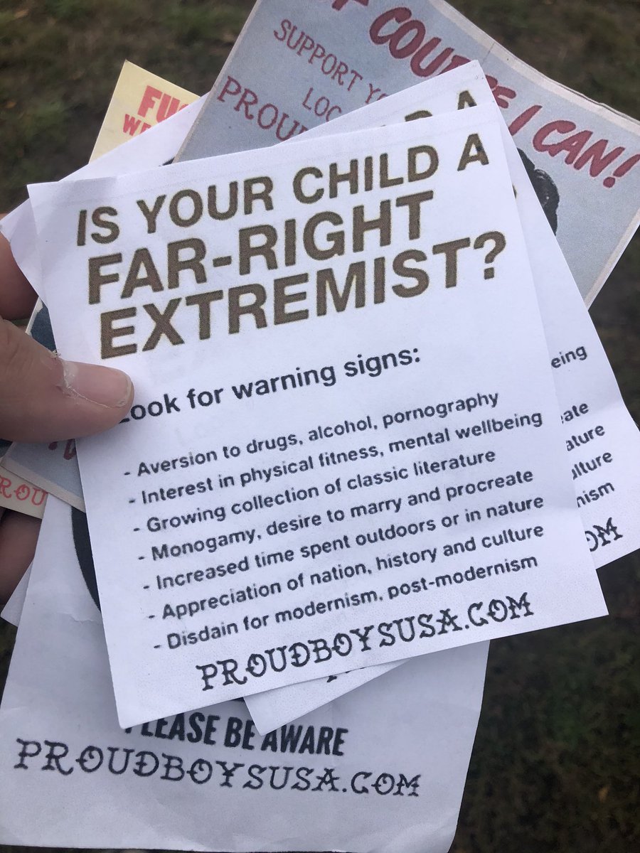 They’re handing out fliers / stickers in the style of WWII and Red Scare-eta art.