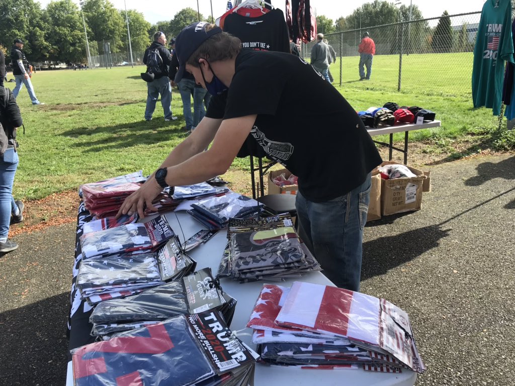 Lots of Trump apparel for sale at the Proud Boys rally in Portland. One man is selling Trump bottle openers that he makes