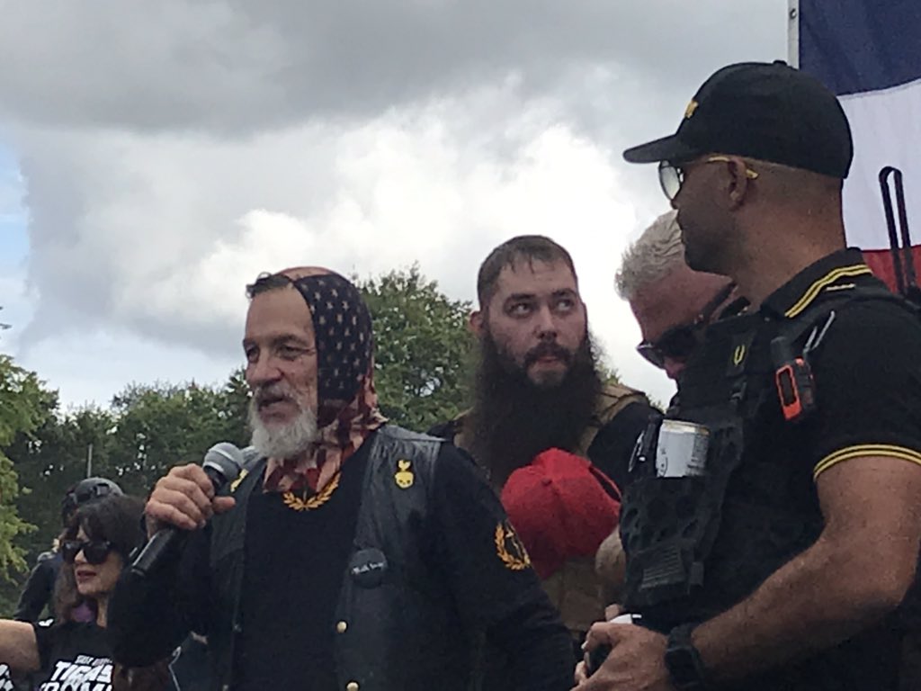 Enrique Tarrio, leader of the Proud Boys, has invited Chandler Pappas on stage as the event in Portland officially kicks off Another man in flag bonnet “Flip,” says he is Vice President of Portland Proud Boys