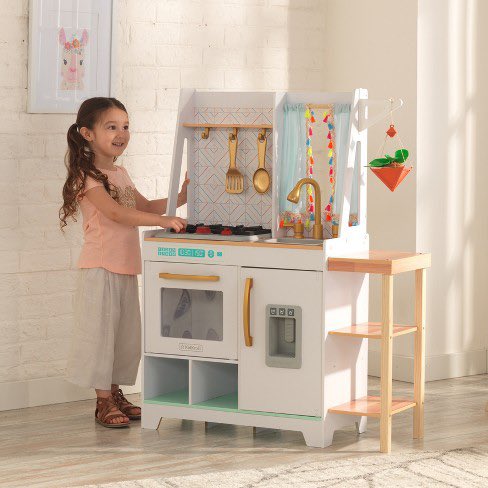 A play kitchen selected by parents who moved to the suburbs to raise their children. The hanging planter almost makes the mother cry when she thinks about their studio in Manhattan and their young idealism.