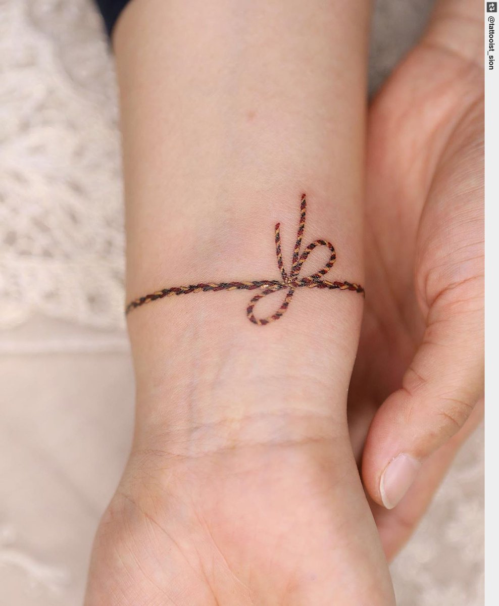 tattooness_com's tweet photo. Ribbon bracelet braided in three colors. #tattoolife #inked #tattooart #tattoos #tattoodesign https://t.co/pQUmg5rMLM