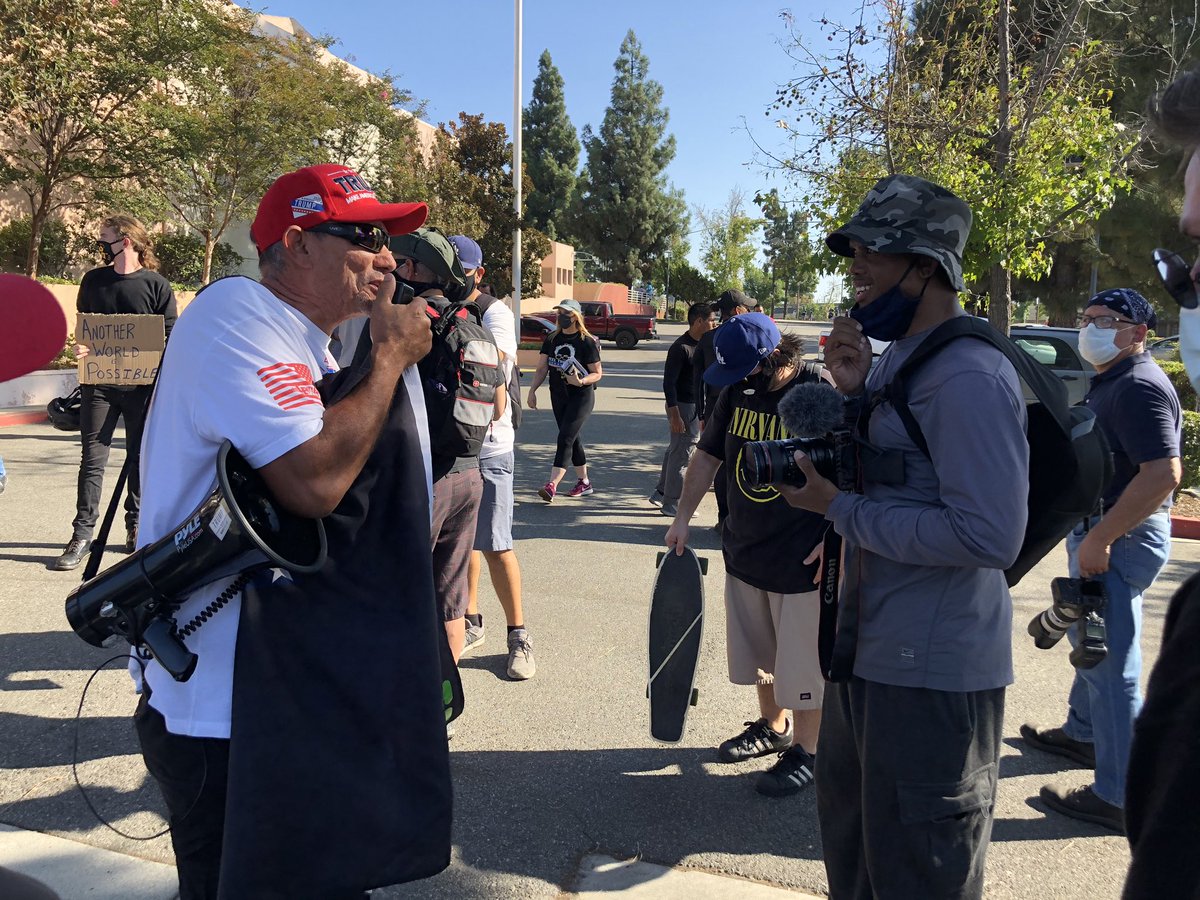 A crowd has once again gathered in the parking lot of the city library, site of the scuffle and where the sedan struck protesters. Right now it’s peaceful, though there are some robust discussions being held.