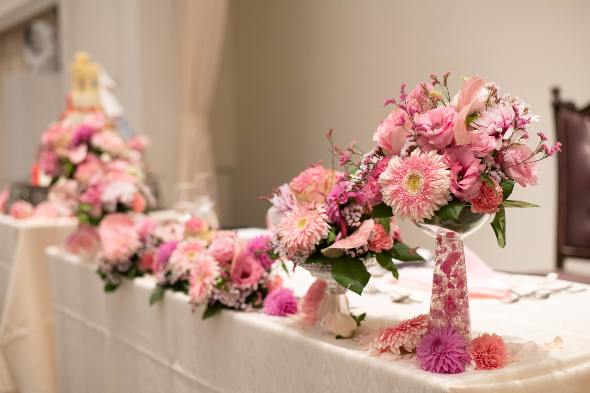 つくば結婚式場 セントルミエール 公式 メインテーブル装花 ピンクで揃え まとまりのある 華やかなメインテーブルに 生花はゲストの方にお持ち帰りも 頂けますのでご結婚式後も お楽しみ頂けます つくば 結婚式 メインテーブル ピンク