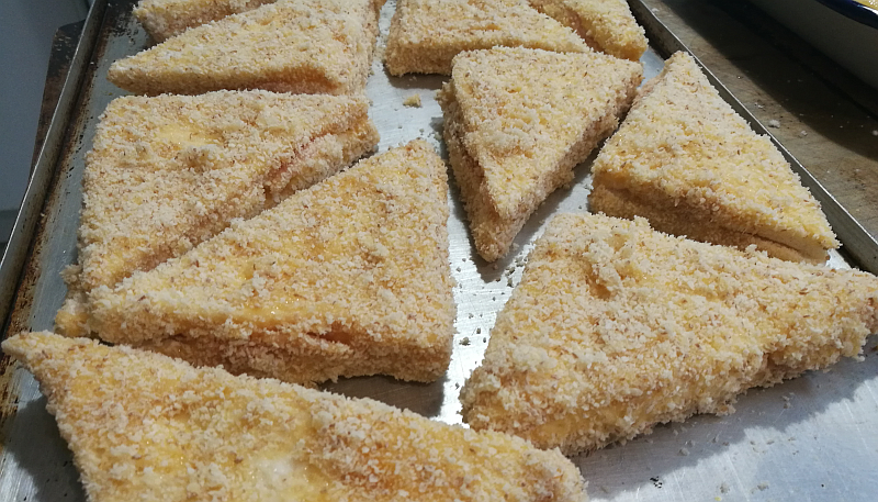 One is to drain the mozzarella of excess liquid. The other is the double coating, so that nothing leaks out in the frying process. You go flour, (salted) egg, breadcrumbs, ensuring at each step to cover the whole surface, including the open sides.