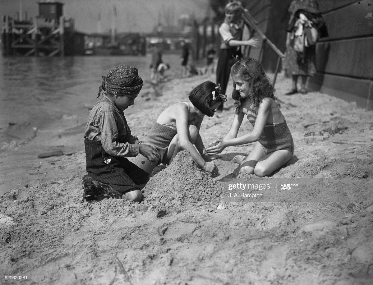 No one is born racist .Making sandcastles on a Thames beach, opposite the Tower of London, 15th August 1939. Photo by J. A. Hampton
