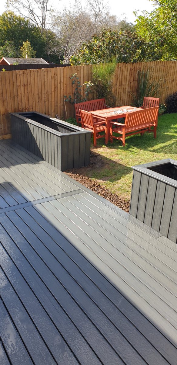 A recently completed Trex composite deck with giant planters