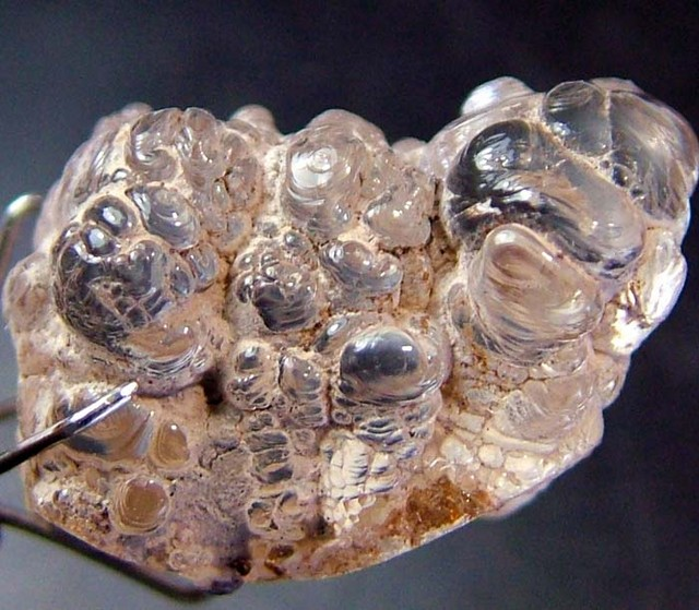 as coatings (hyalite) in volcanoes and fumaroles(image:  https://df2sm3urulav.cloudfront.net/tenants/o...