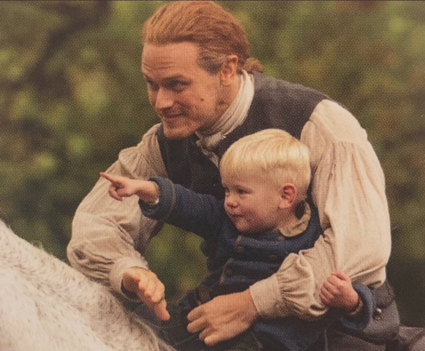 New_Sasha's tweet photo. Caitríona and Sam snuggling Adso, and the wee little guy clutching Sam’s arm....this is too much 🥺❤️😍 https://t.co/nw86tdPNrS
