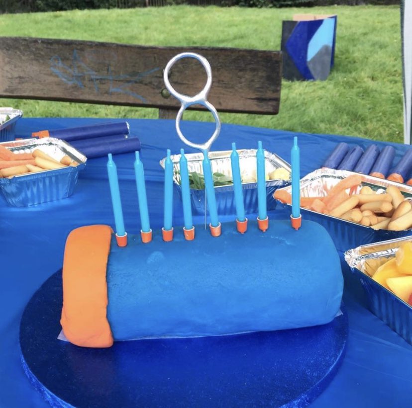 We also had giant darts made of pool noodles I sliced and taped up but I can't find any pics of those. I made a swiss roll Nerf dart cake (which turned the kid's tongues blue) and packets of sweets for favours