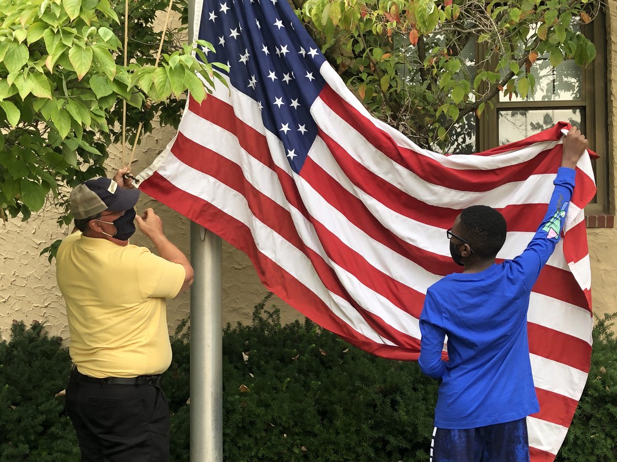 JBSchool's tweet photo. 7th graders are responsible for raising the flags each morning at the Price Road entrance and in the Quad. Student assignments for flag duty rotate weekly. Here Ed Phillip, Director of Plant Operations, is teaching a 7th grader how to raise the flag. #jbsstudents https://t.co/EhKuFdyz7R
