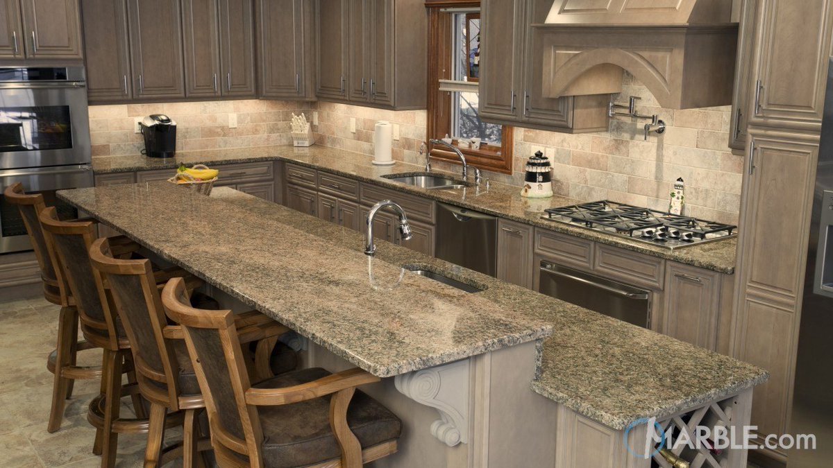Marbledotcom's tweet photo. Rustic and modern elements come together in this fabulous kitchen. Key West Gold granite finished with a Straight Edge melds with a neutral tile backsplash and cabinets. #granite #naturalstone #kitchens #countertops #countertopideas #kitchenremodel #kitchenisland #homereno https://t.co/FuBriXktSS