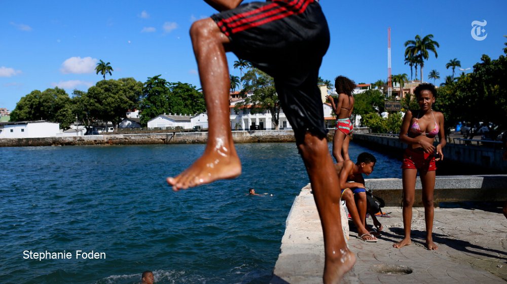 nytimestravel's tweet photo. Vivid street scenes from Salvador, Brazil, where the act of celebration is indelibly ingrained. See the full photo essay by @stephaniefoden https://t.co/gvR6xx8G3S https://t.co/SRkFDgrCAW