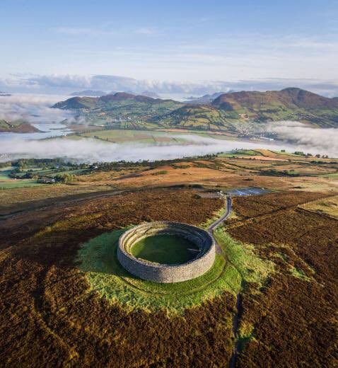 Grianan of Aileach dates back to at least the 6th C AD. It is one of the most important monuments in Ireland. It is a stone fort which suffered depredations under the King of Munster who was said to have carried off its oaken roof in 1101 AD. It has been conserved & is stunning.