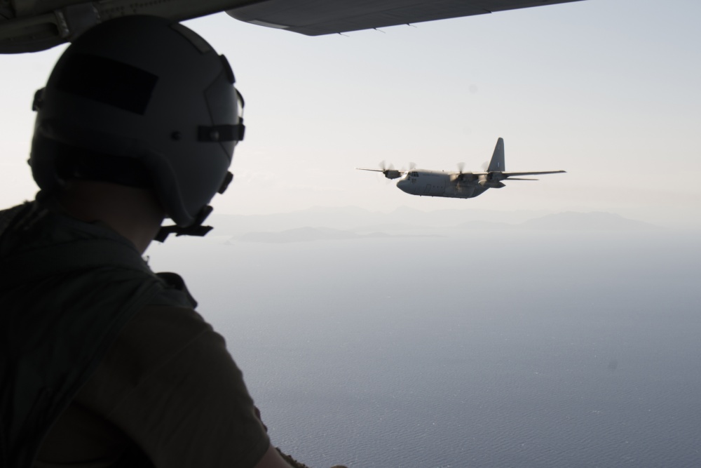 U.S. Air Force Senior Airman Brice Breshears, 86th Maintenance Squadron maintainer, watches a C-130J Super Hercules aircraft assigned to Hellenic forces during Operation Stolen Cerberus VII at Megara Bay, Greece, Sept. 14, 2020. The exercise is designed to enhance readiness and demonstrate a shared commitment to a peaceful, stable and secure Europe. (U.S. Air Force photo by Airman 1st Class Taylor D. Slater)