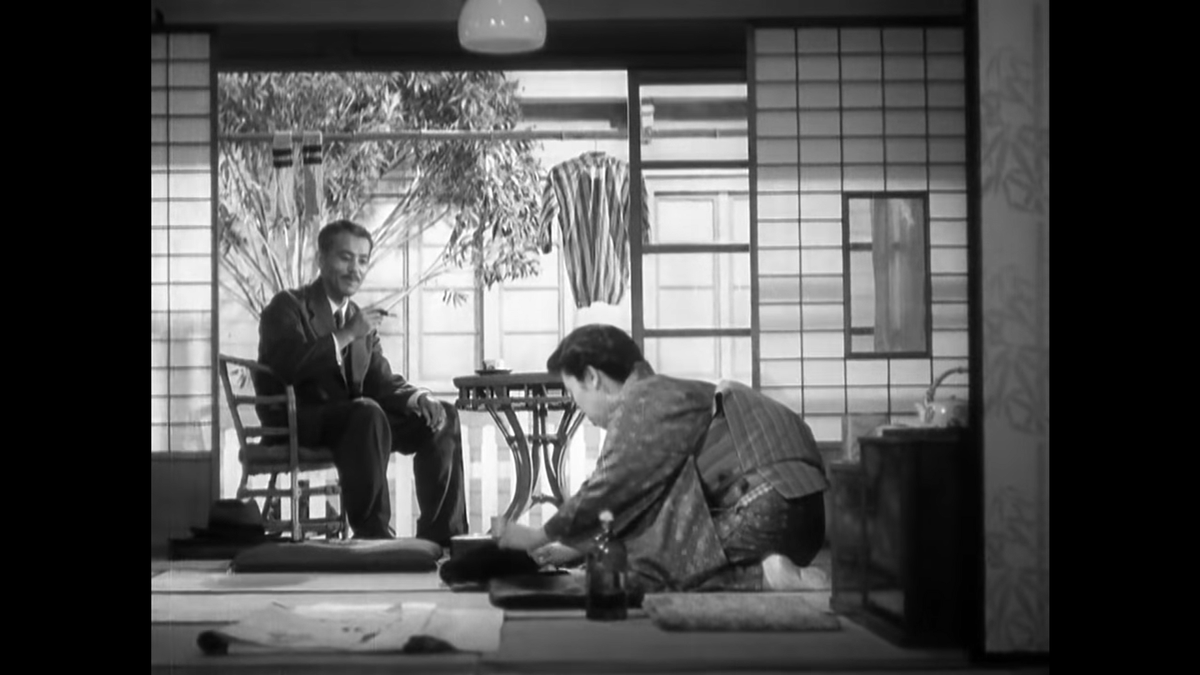 We are now at Aunt Masa’s house as the central conflict really begins. Shukichi begins the scene in a chair but moves to the floor; it’s a move likely made with aesthetics in mind but he’s also being brought back to tradition by the talk of his daughter’s need to be married.