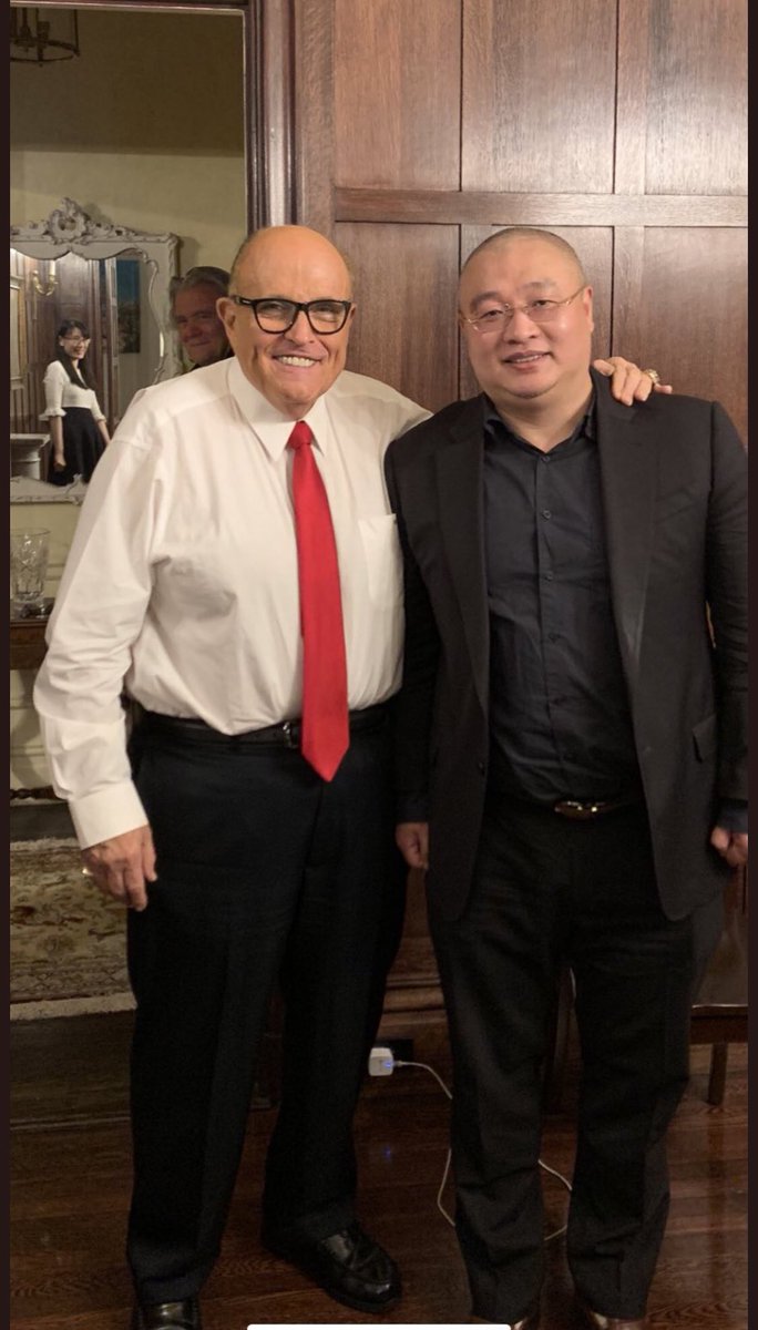 Here she is with Rudy Giuliani and Steve Bannon. She works with Guo, Steve Bannon’s billionaire Chinese benefactor, who is on the run from the Chinese government. (Guo not pic’d here.)