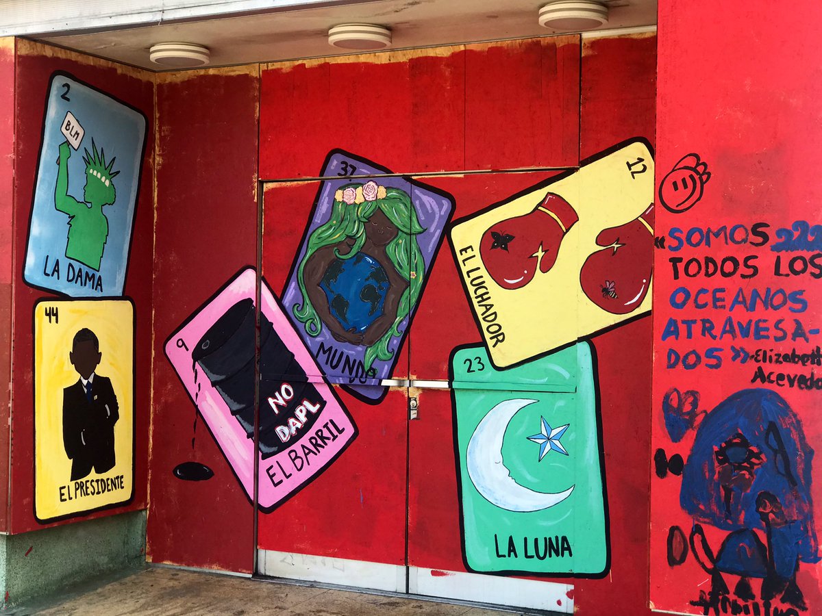 Looking at a mural in the 1900 block of Telegraph Avenue that shows social justice versions on Spanish-language tarot cards Thursday, September 13, 2020 in Oakland, California