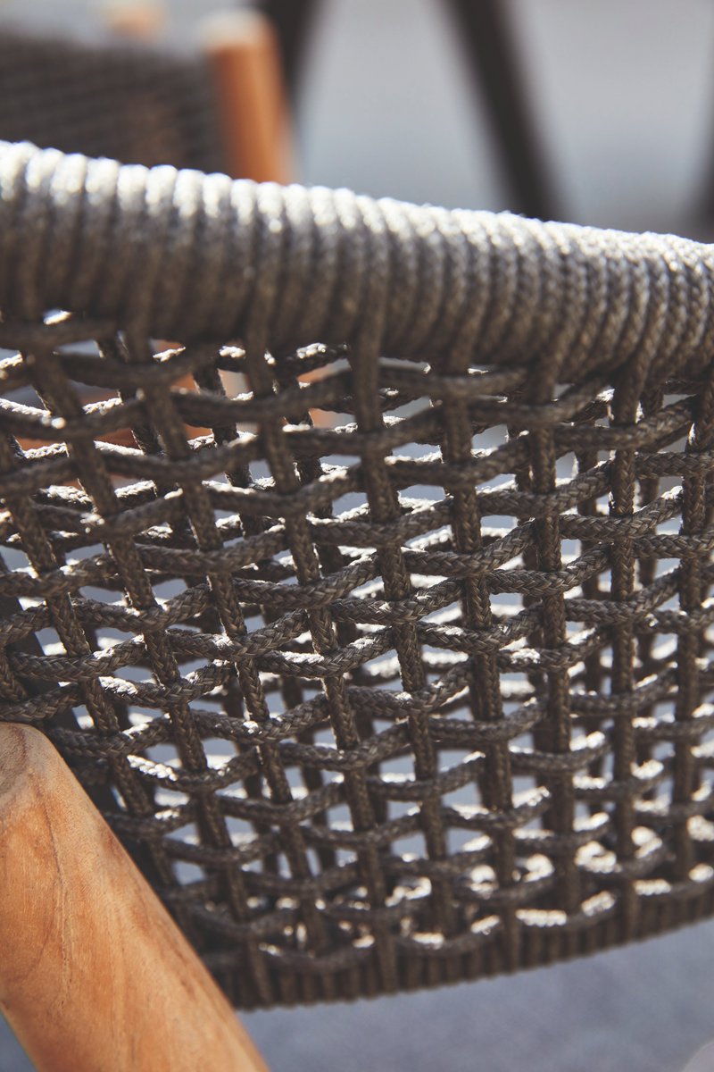 Striking yet durable; our Spirit armchair details an intricate graphite rope weave on a Grade A Teak frame complementary to all Akula dining tables.

#interiordesign #hospitalitydesign #contractfurniture #outdoorfurniture #designerarmchair