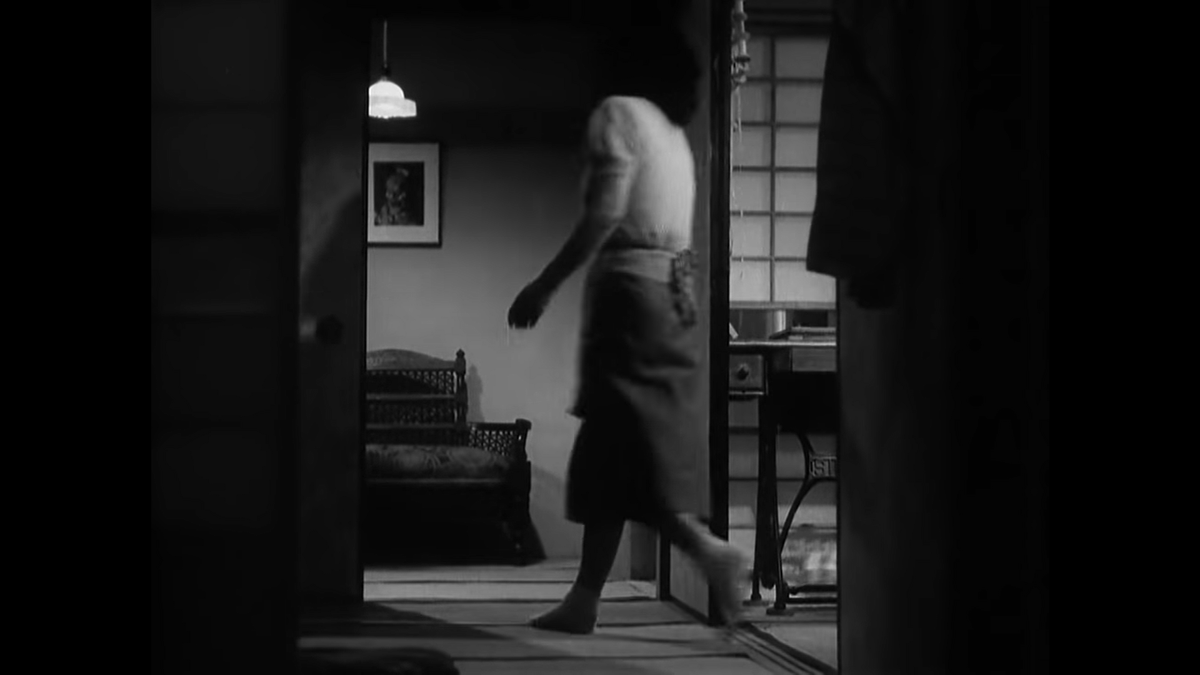 Here's Noriko going to greet Shukichi at the door. The geography of the rooms never feels quite right in an Ozu movie despite frequent uses of people moving from room to room and objects positioned in a way to orient you through cuts.