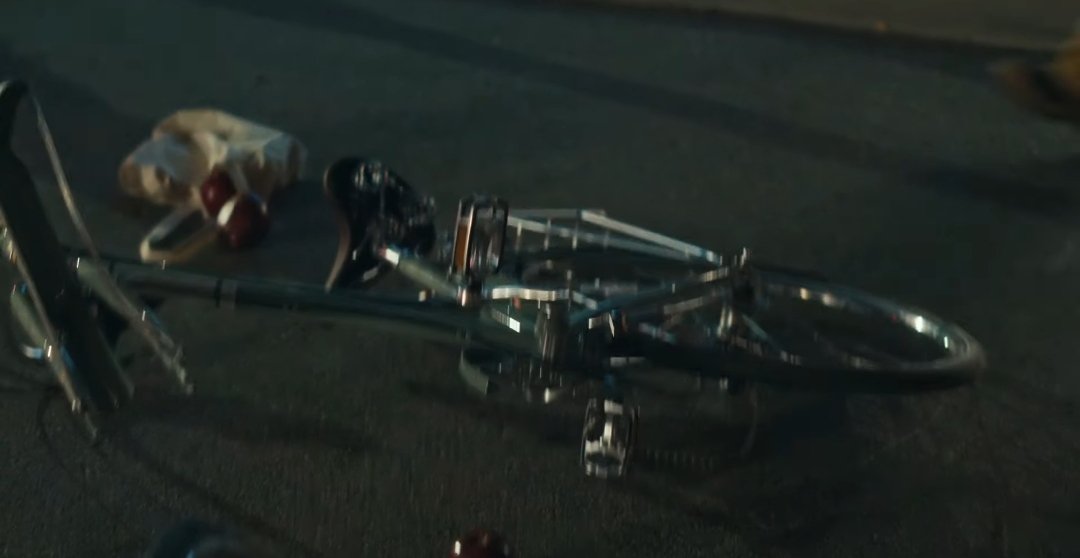 Next scene shows us a representation of the accident Gaga went through but how she imagines it in her head. In real time, at this point she died. We see her foot with a red bracelet symbolizing the blood and a reference to The Color of Pomegranates (1969). Also the bike