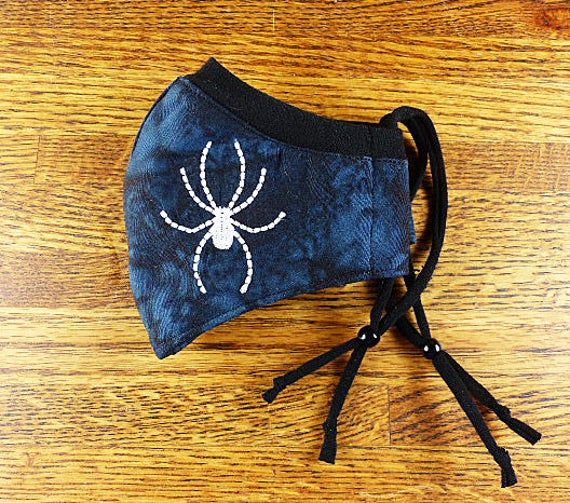 SantaFeKiss's tweet photo. Spider Embroidered on Washable, 3 layer face mask w Stretchy nose band to help eliminate fogging of glasses w Filter pocket / Handcrafted in the USA #fallfacemask https://t.co/z79u9nDPj6 via @Etsy https://t.co/mD80RhdOGS