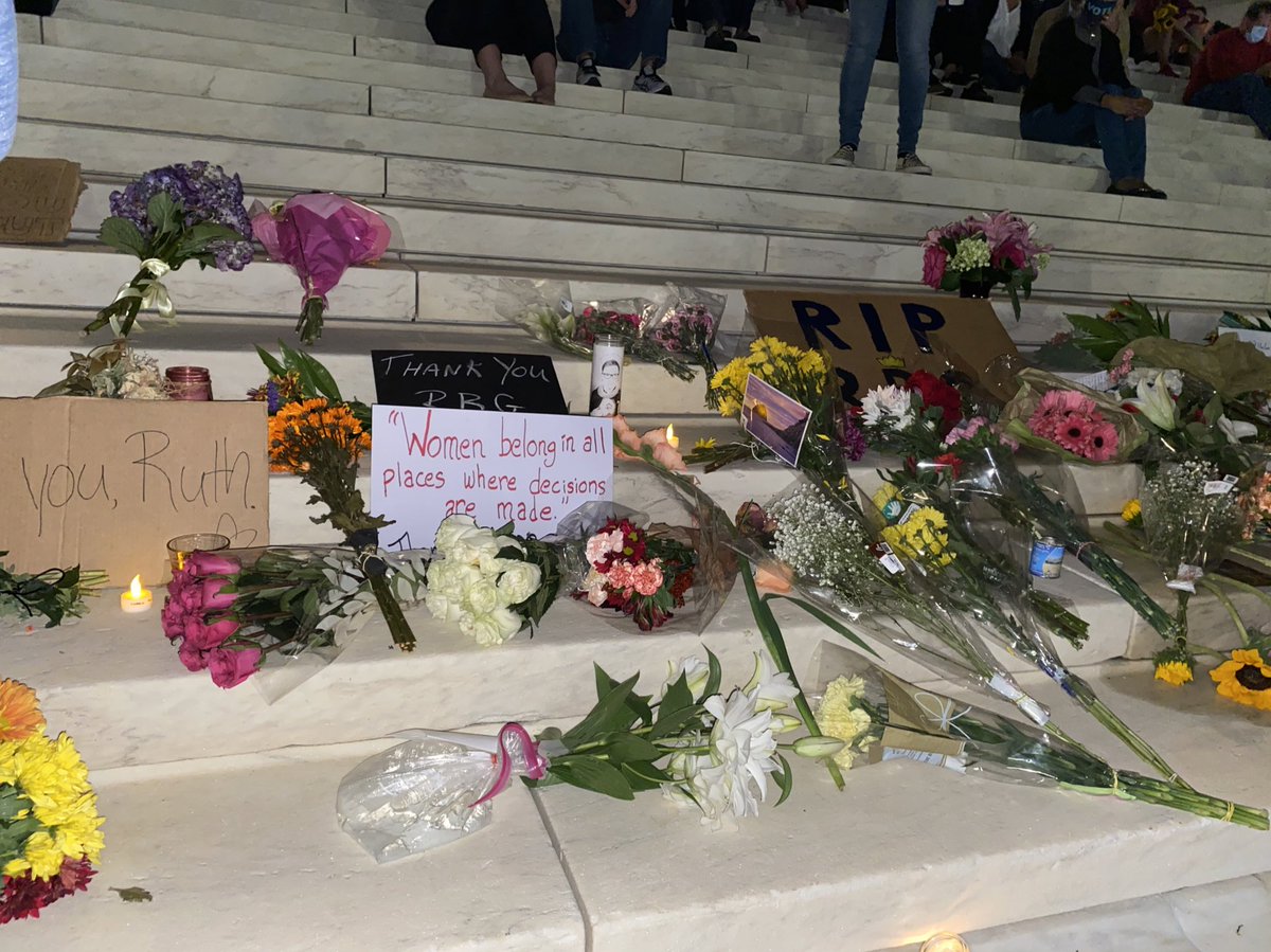 Phil_Lewis_'s tweet photo. Flowers and signs honoring Ruth Bader Ginsburg are on the steps, with one sign that reads: “Women belong in all places where decision are being made," she once said. https://t.co/YI38Os85RG