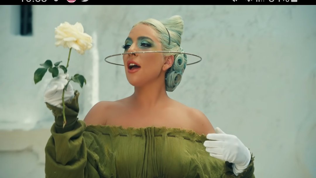 Next scene which is now already iconic, Gaga in real life was about to die completely with a white rose, she was going to heaven but then the nurse and cop bring her back to life as we can see in the quick frame. The rose dies. Reference from Fellini of 8 1/2