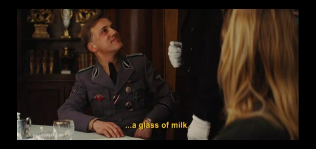 In the first scene, there is emphasis on milk and how hans landa absolutely loved the glass of milk in la pedite's house. He knows that Shoshanna heard all the conversation that happened there. Just to terrify her, he orders a glass milk for her.