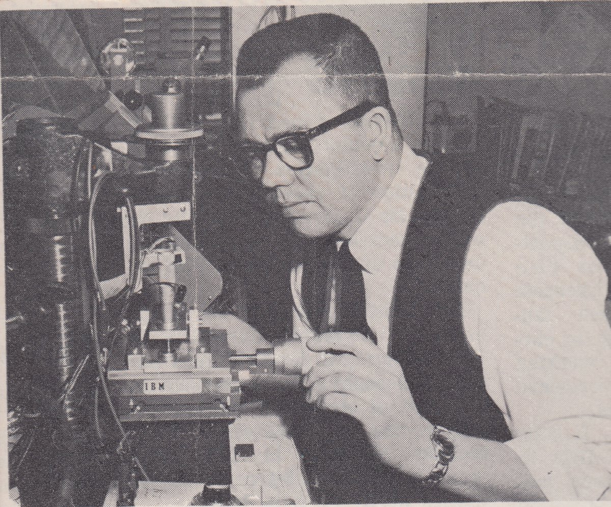 A man in thick-framed glasses at the computer