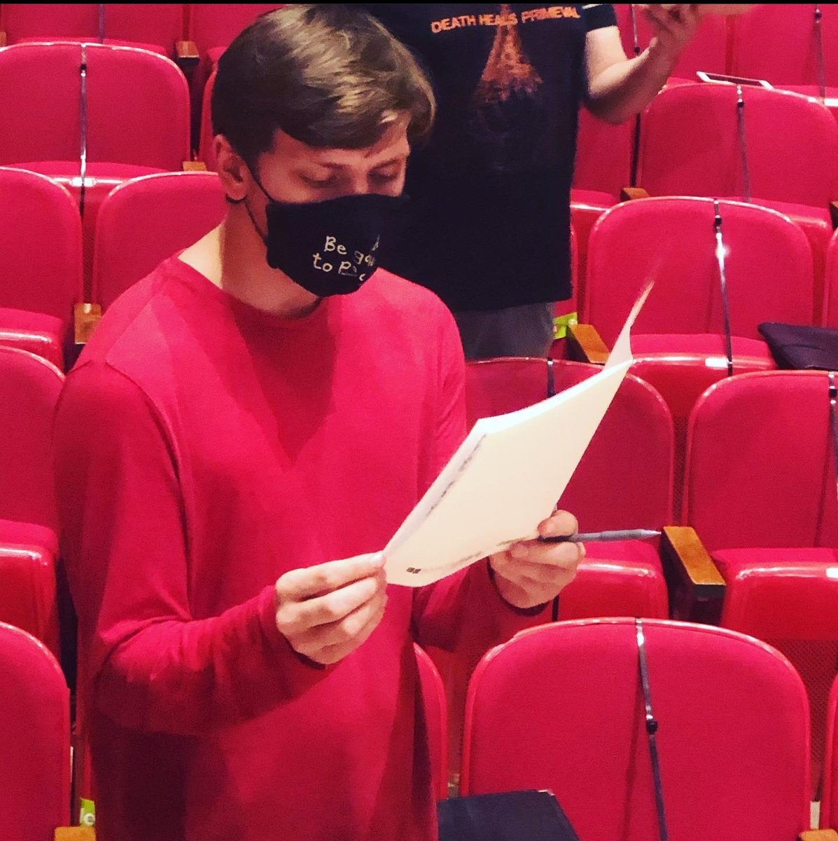Meet Ean. Ean is trying to be incognito and blend in with the Kimball Recital Hall seats today. He baritone in Varsity and is a talented sophomore majoring in computer science and music composition and he graduated from Lincoln Southwest High School. (1/2)
