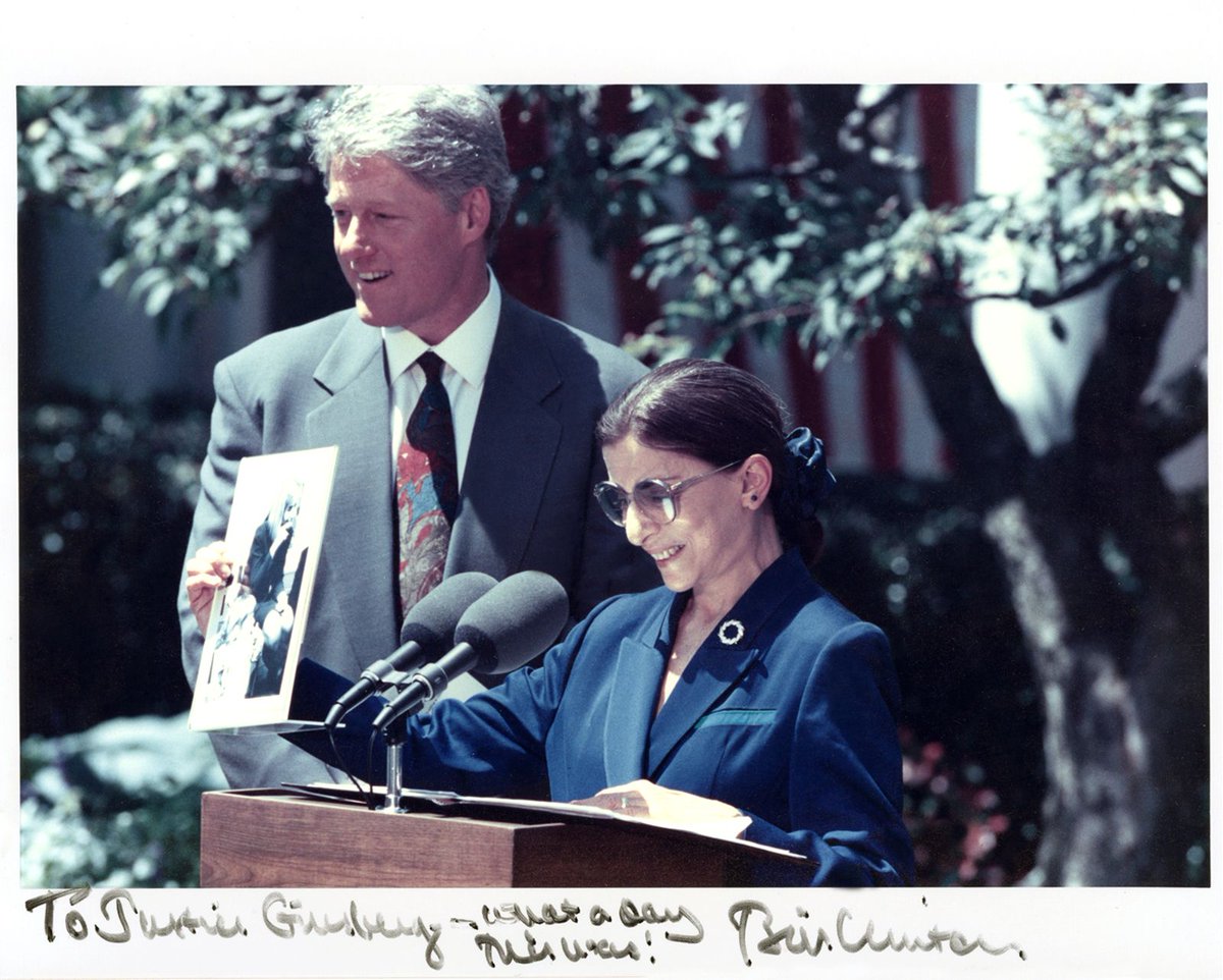 At the press conference announcing her nomination in the Rose Garden, Ginsburg holds up a photo of Hillary Clinton singing "the toothbrush song" with Ginsburg's granddaughter Clara and her nursery school class.