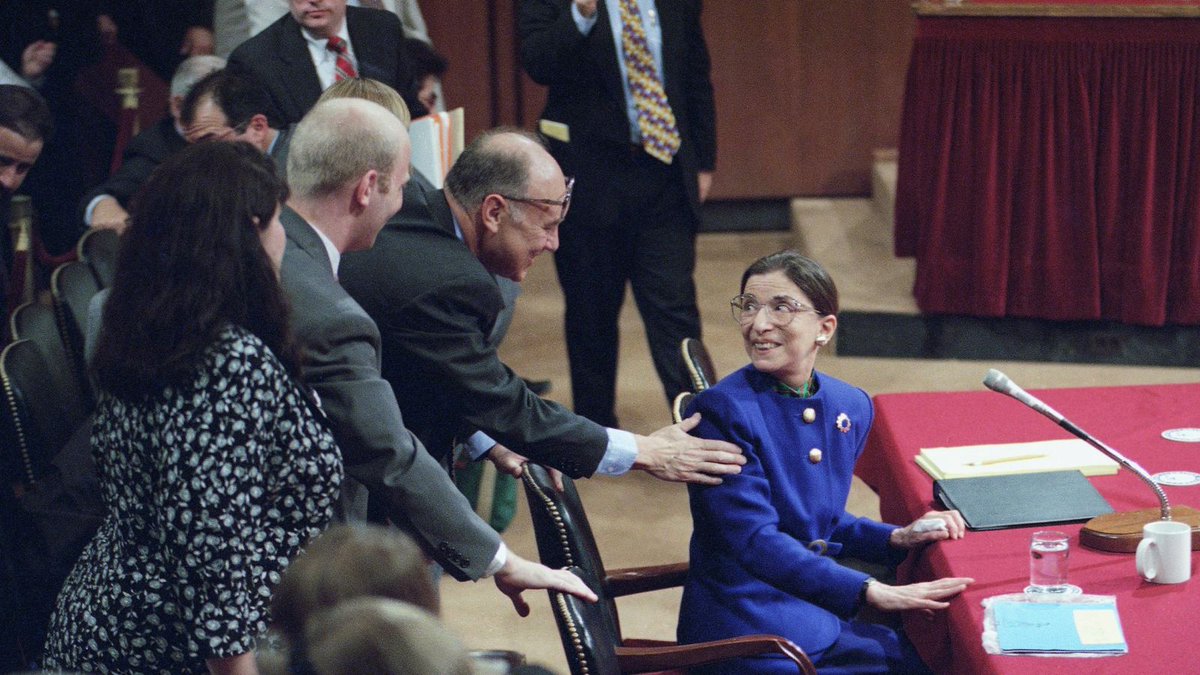 1) Ginsburg speaks with reporters, with Sen. Daniel Patrick Moynihan (left, bowtie) and Sen. Joe Biden (right).2) Marty greets her at her confirmation hearing. He again campaigned tirelessly to get her the nomination, soliciting countless endorsements and persuading opponents.