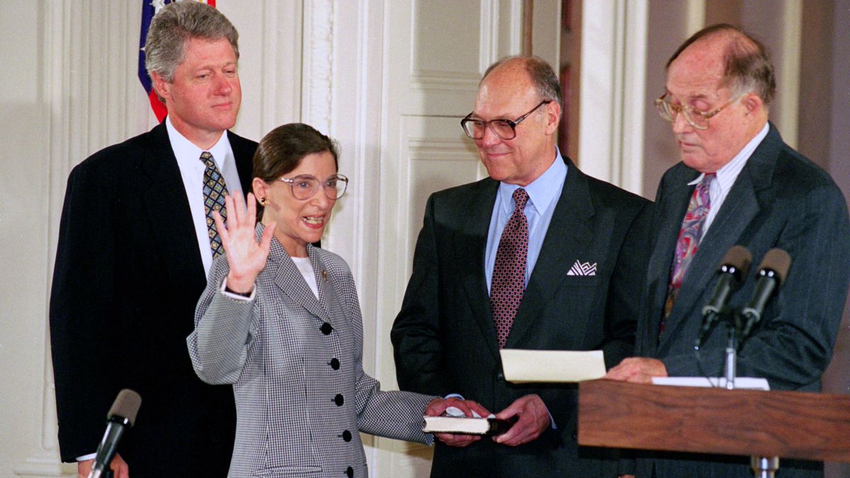 1) Sworn in by Chief Justice Rehnquist, as Marty looks on, adoring.2) After the ceremony, posing with family, she holds the hands of her granddaughter Clara and grandson Paul.3) An informal group photo taken of the US Supreme Court in December 1993.