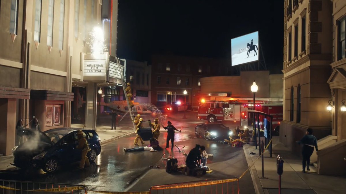 This next scene shows how the guys in blue (police) and in yellow (firefighters) are almost like announcing Gaga's death in her world because of the horse. But they were running to help everyone, like what they do after you call 911