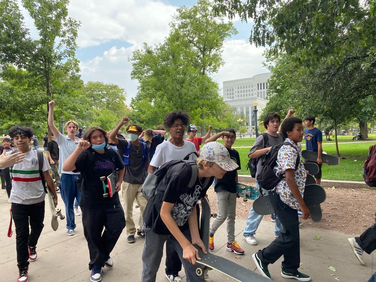 Dozens of kids on skateboards riding alongside the march in solidarity!