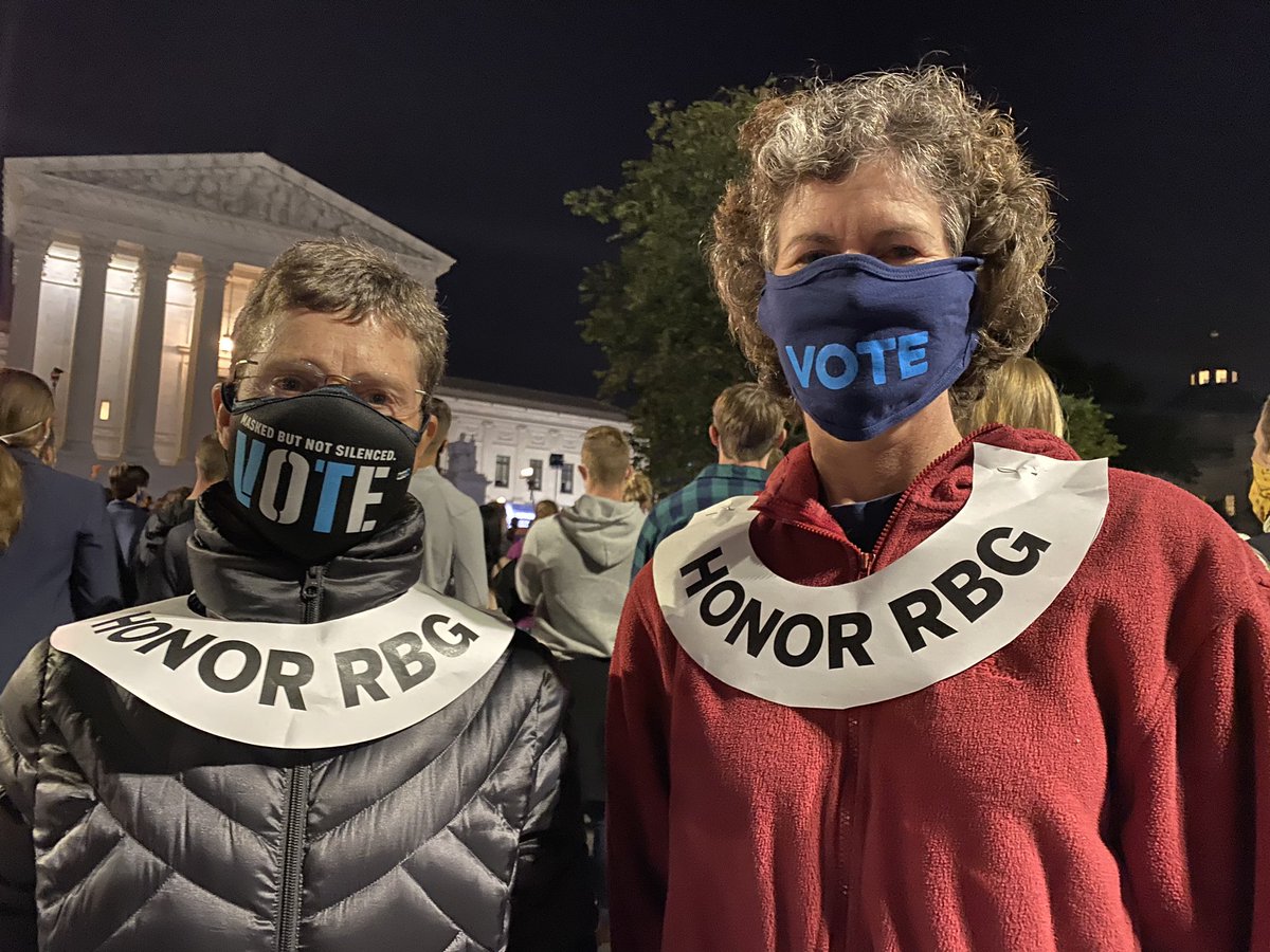 These collars made of paper and affixed with straight pins! Lots of emotional folks out here. The woman to the left choked up when I asked her what brought her out tonight and then her friend interrupted “We lost an icon.” – bei  Supreme Court of the United States