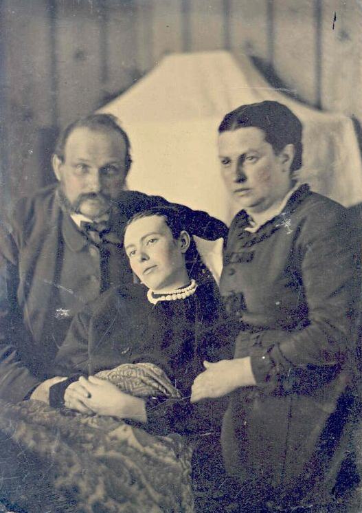 Victorian era post-mortem family portrait of parents with their deceased daughter