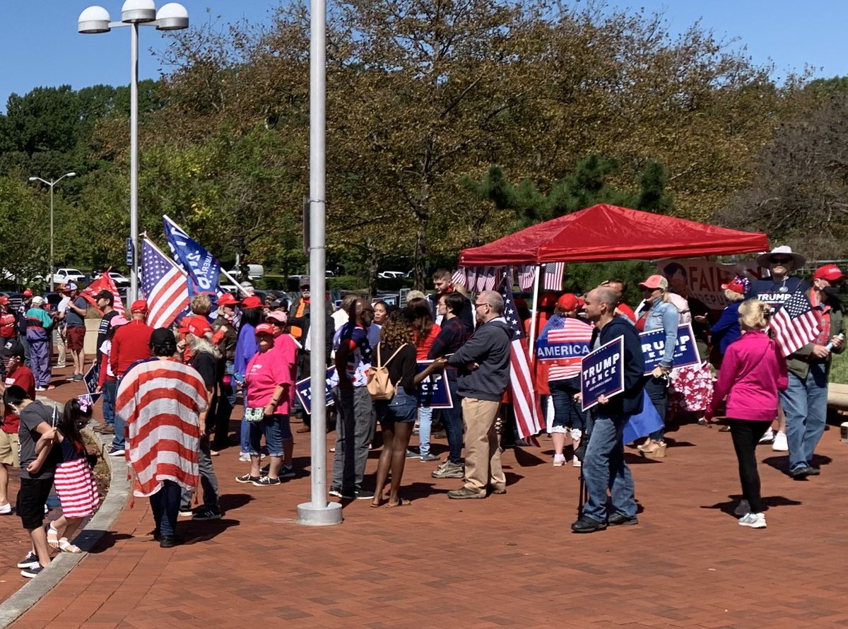 As more Trump supporters arrived at the entrance, they ended up blocking the sidewalk that is the path from the visitor parking lot at the center. They also took down one of our large sample ballot A-frame signs in this mess. No masks.