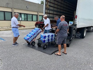Hurricane Sally relief supplies  arrives at local Coldwell Banker office. Mike Mangrum and Denis McKinnon met the truck filled with water at the local Pensacola Coldwell Banker office. The Pensacola office will serve as both the staging and distribution point for supplies.