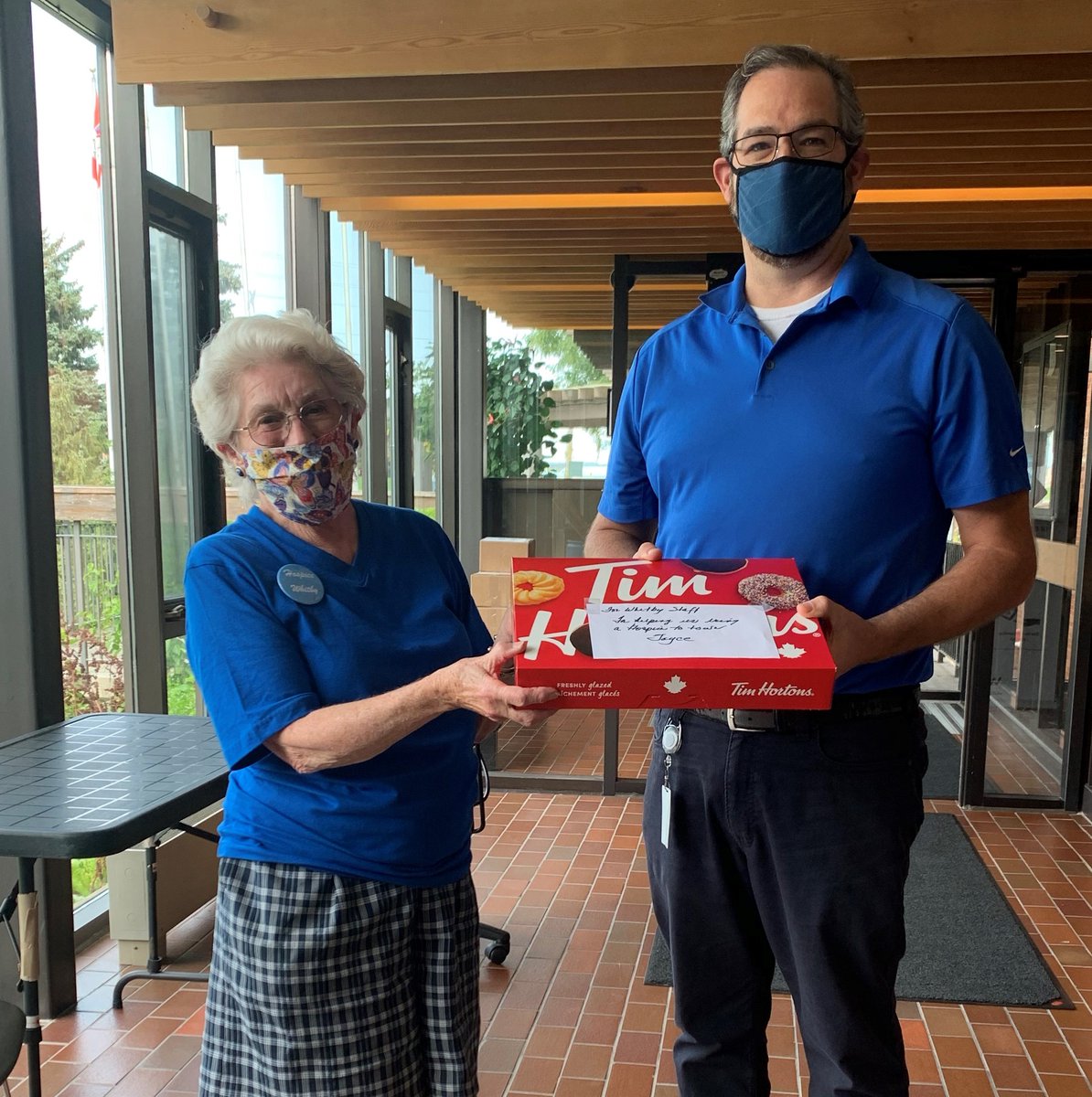 DurhamHospice's tweet photo. Durham Region Hospice  volunteer  Joyce presenting a box of Tim Horton’s Smile  cookies to Whitby CAO Matt  Gaskell   for town staff  to say thank you for their  support  in helping bring hospice  to Whitby. https://t.co/QKQxrjtuux
