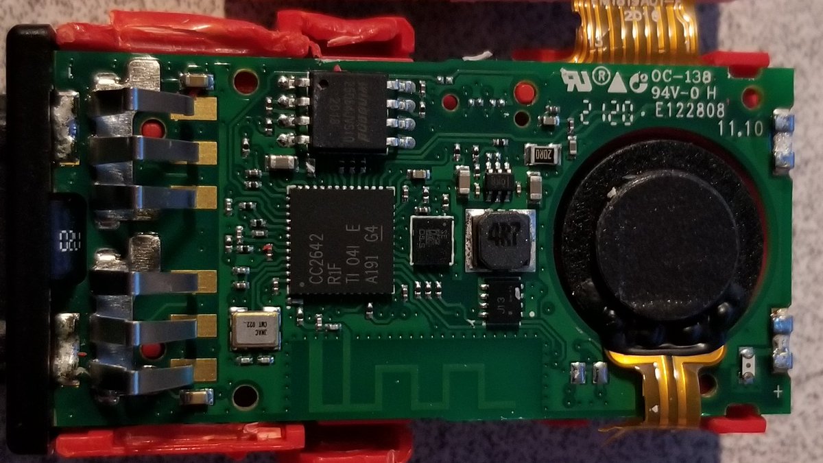 Here's the main PCB.We've got a big CPU in the middle, a tiny chip next to it, an eeprom/flash looking chip above, and a big speaker on the right.(The metal bits on the left are buttons)