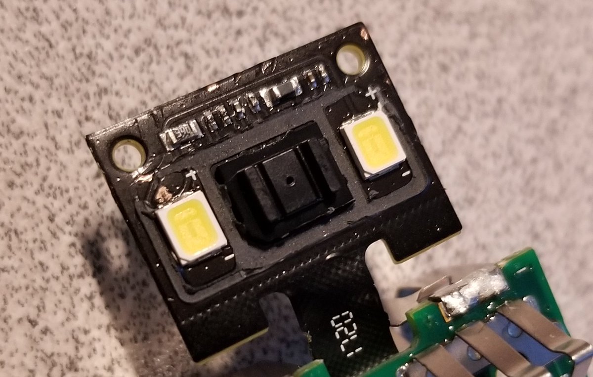 Here's the LED/camera assembly. Two LEDs and some kind of optical sensor in the middle. I suspect it's only a few pixels, it doesn't need to be many for what it does.