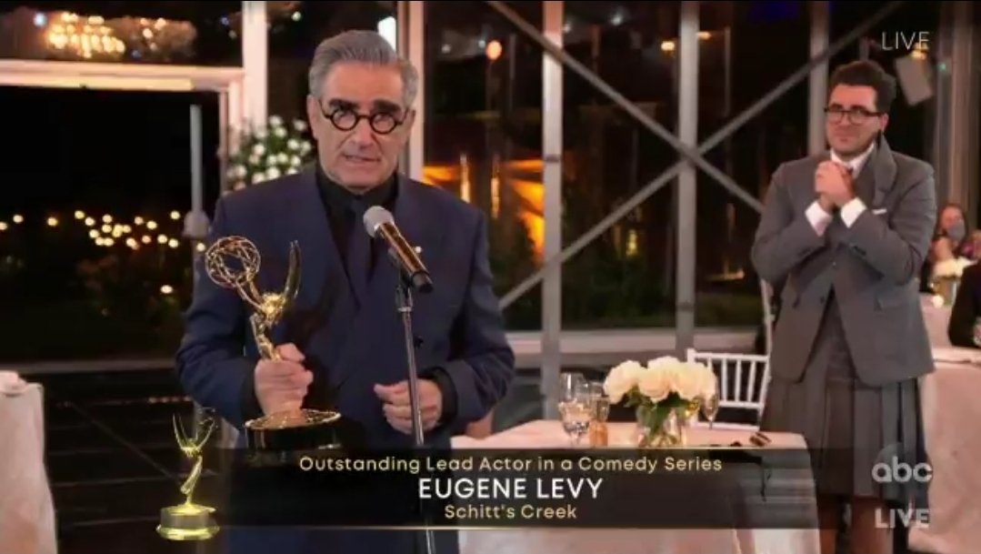 chelsaya's tweet photo. dan levy watching eugene levy accepting an emmy is so precious my body actually physically hurts https://t.co/QmwNtWU020