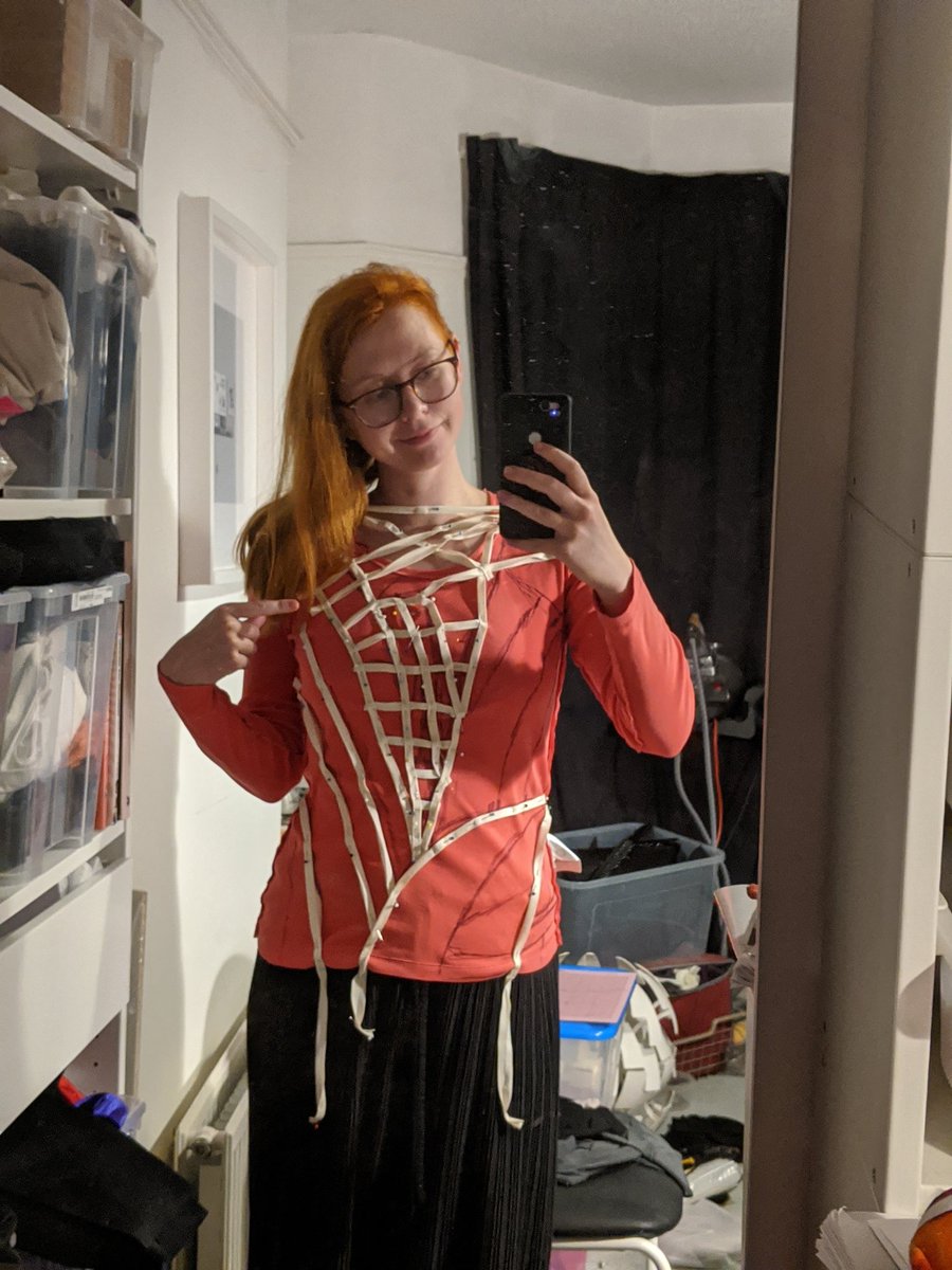 Starting with the underlayers. I got this cheap top from a charity shop, took it in to be more form fitting and mapped out the style lines with a sharpie, using the designs as reference. Once the sharpie lines were done, I duplicated them with cotton tape