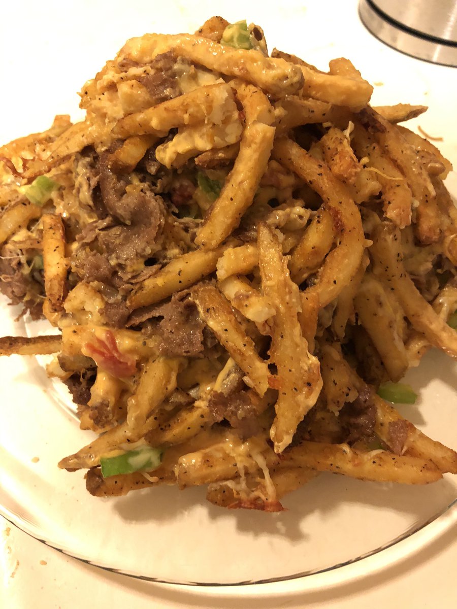 Philly Cheesesteak fries (steak, fries, shredded cheese, cheesewhiz, and bell peppers)