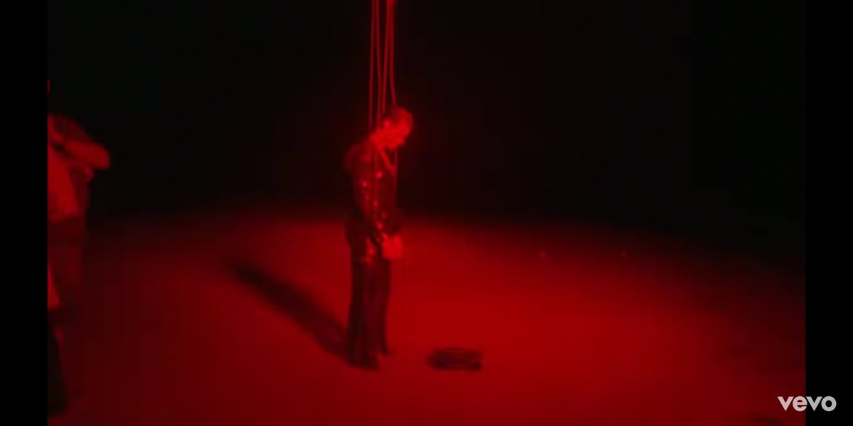 These shots are very fleeting but explicit. We see H strung up by strings like a puppet, glittery show clothes on, a man behind him in the first photo. This adds to the lyrics that are a fuck you to those who controlled him and kept him closeted.