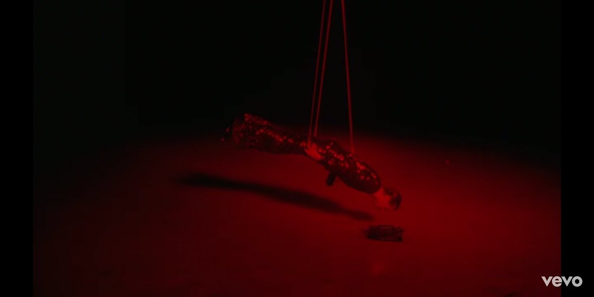 These shots are very fleeting but explicit. We see H strung up by strings like a puppet, glittery show clothes on, a man behind him in the first photo. This adds to the lyrics that are a fuck you to those who controlled him and kept him closeted.