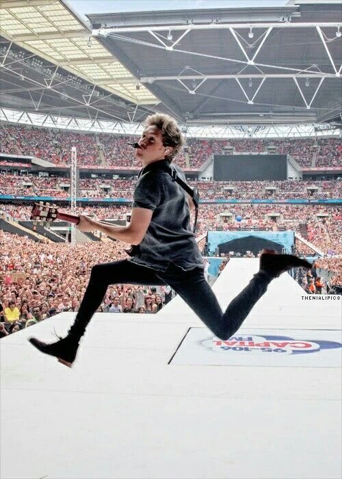 the jumping with a guitar in the OTRA era jump